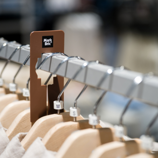 A rack with shirts and size markers